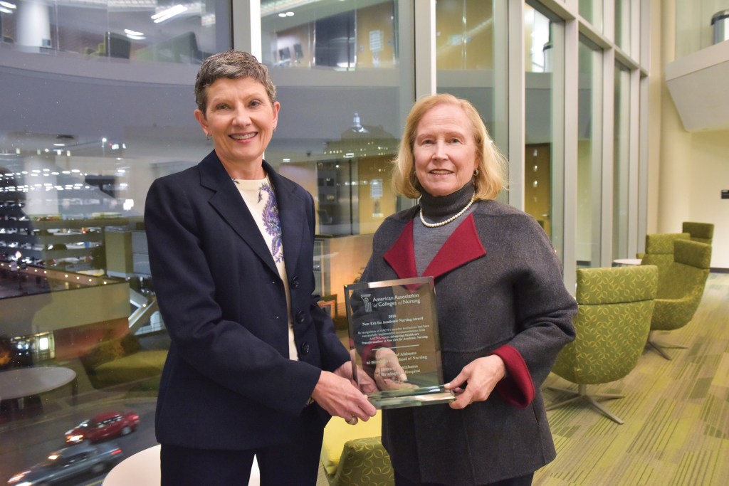 Terri Poe and Dean Harper with New Era Award