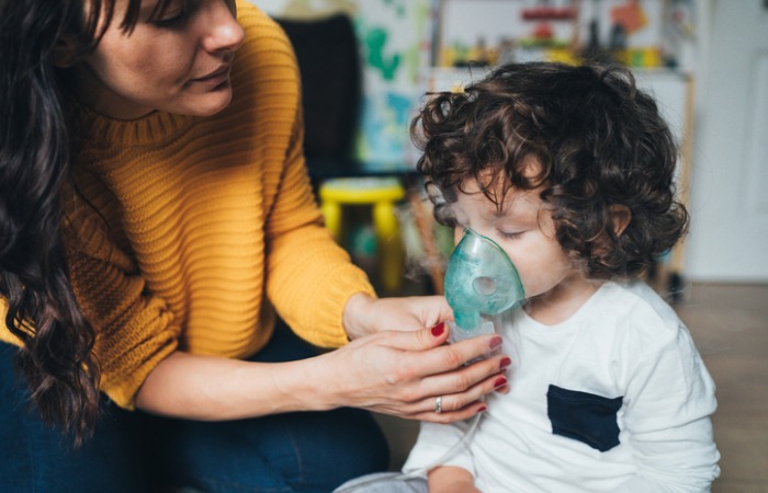 Mother delivers breathing treatment to son