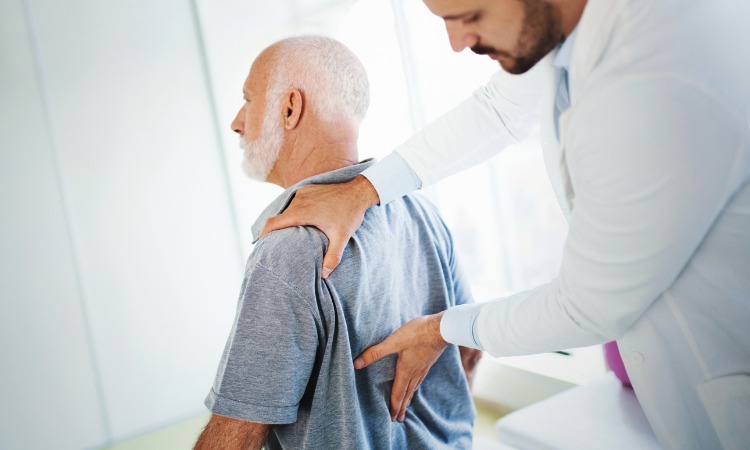 Doctor examining patient's back