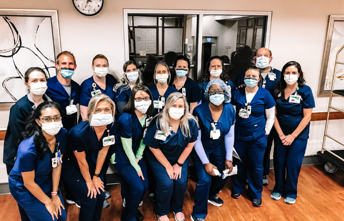 Group photo of nurses in blue scrubs