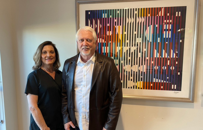 Couple standing in front of AGAM donation in Callahan Eye Hospital