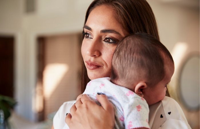 Mother holding infant daughter