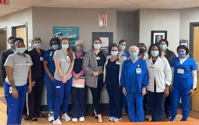 Group photo of nurses in blue, grey and white scrubs