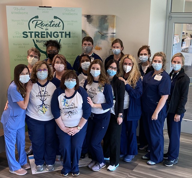 Group photo of nurses in blue scrubs