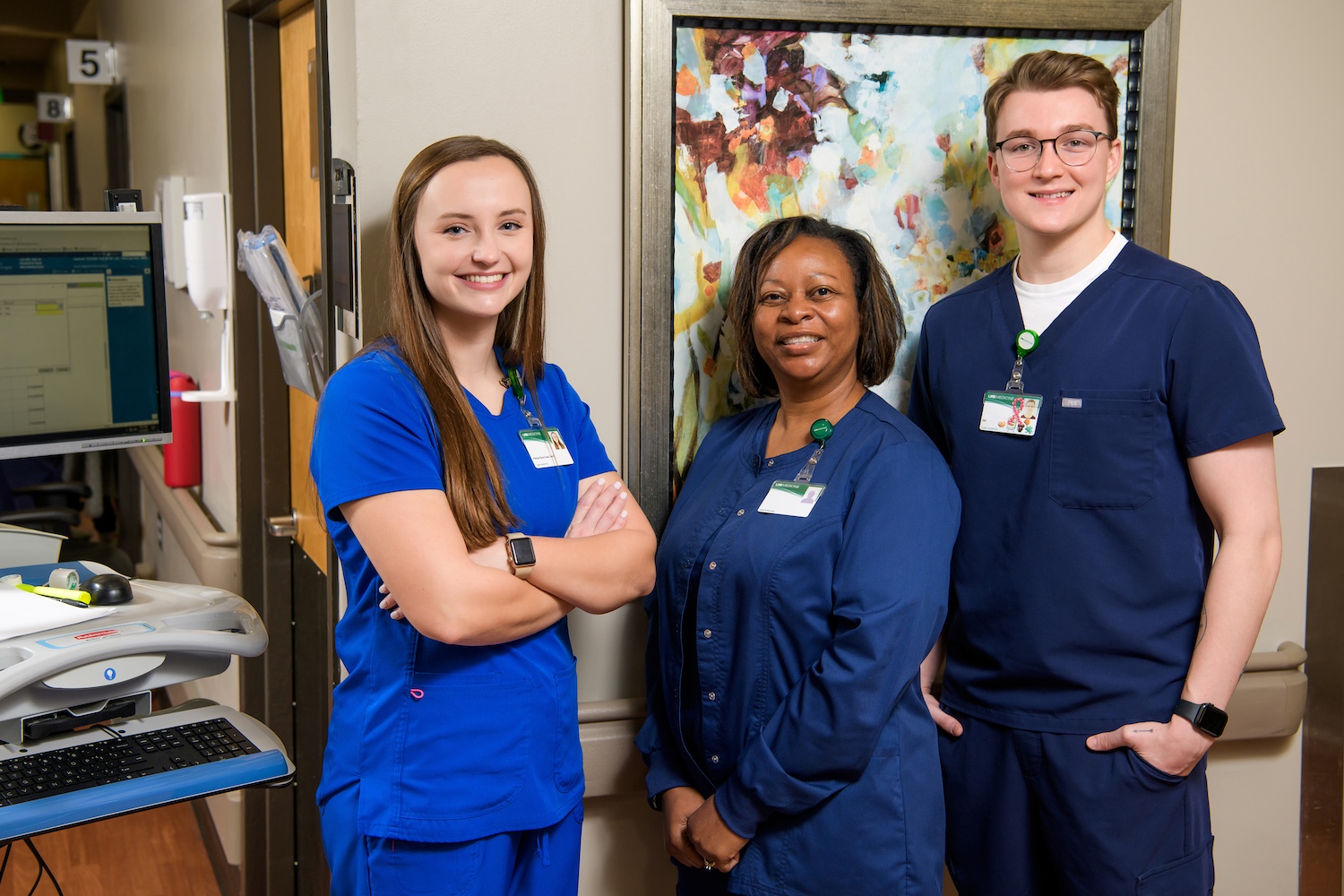 Patient care tech (PCT) and registered nurses (RNs) smiling