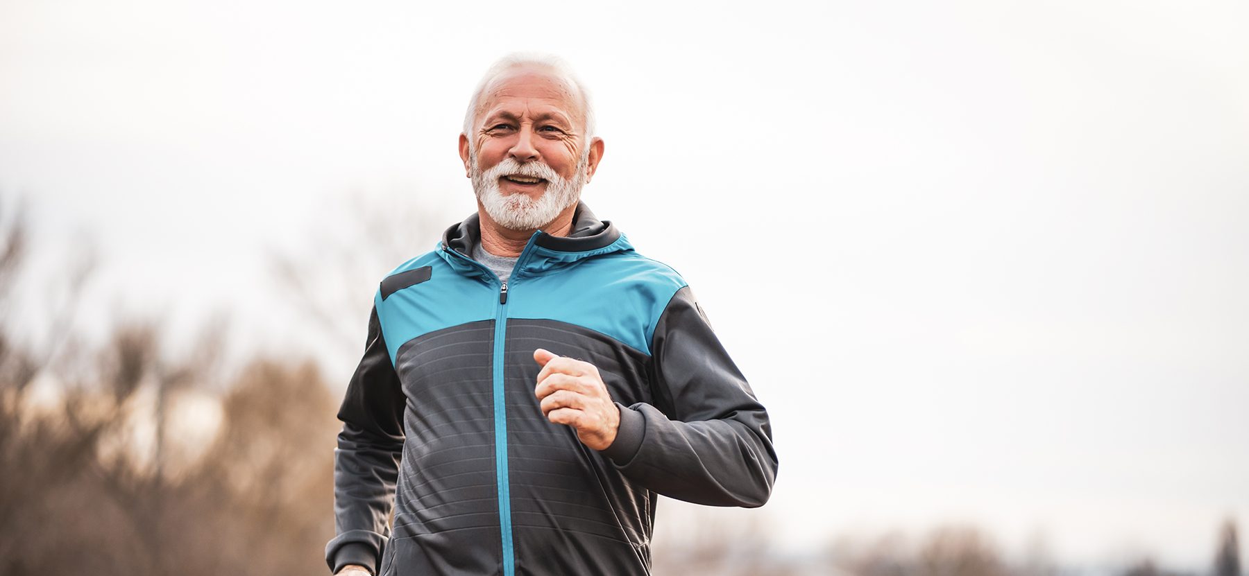 Active senior man is jogging.