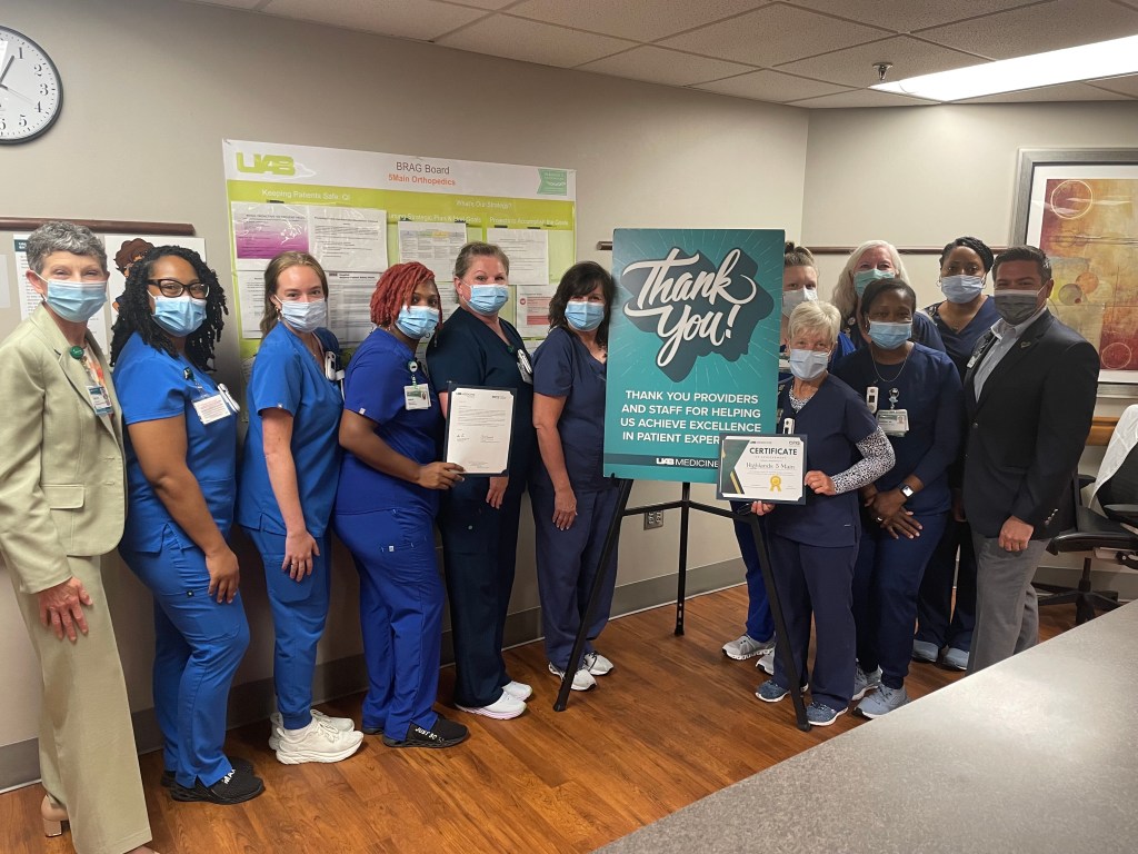 Group photo of nurses in blue scrubs