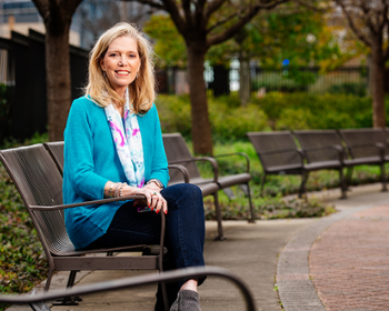 Jeana Nesmith Russell sitting outside on a park bench