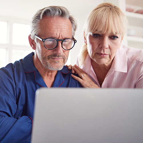 Elderly couple looking at a computer screen together