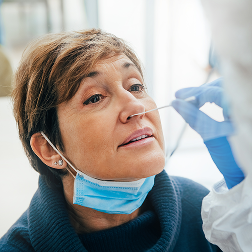 Female patient receiving a nose swab for a COVID-19 test