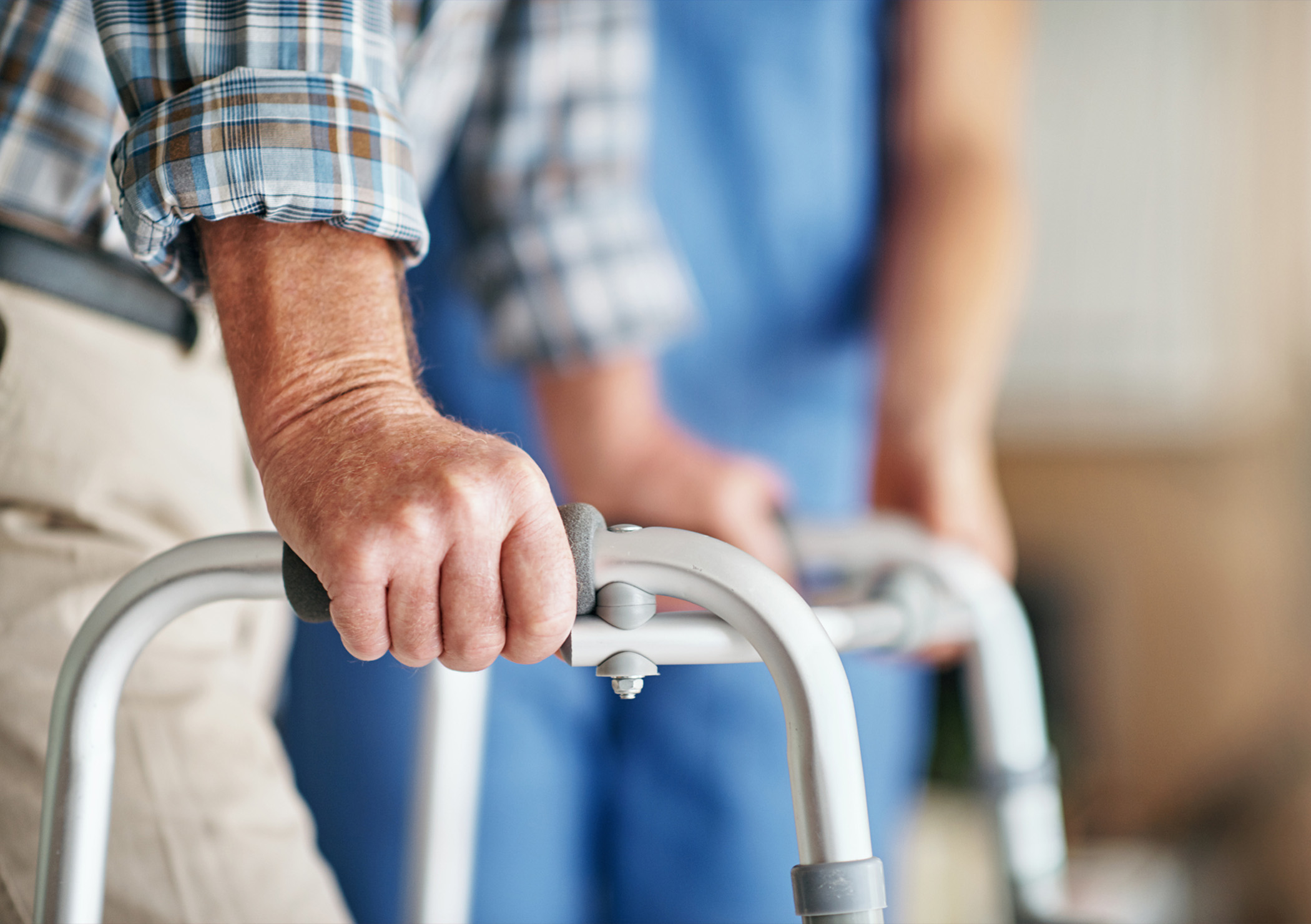 Hands holding a walker