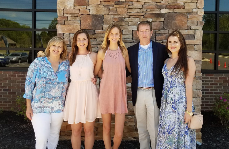 Stanfield family posing together in front of their church