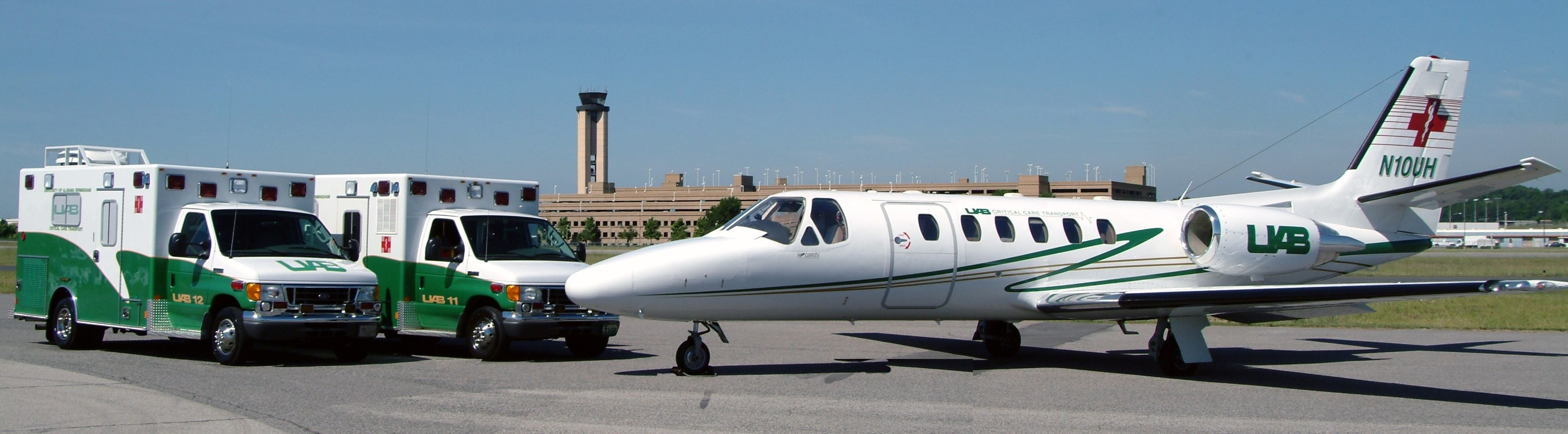 Two UAB ambulances and one UAB jet parked at an airport