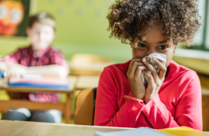 African American young female covering nose with a tissue