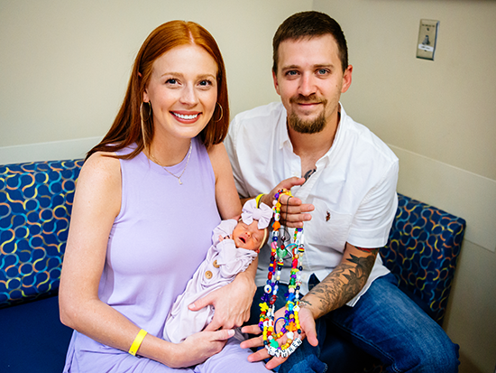 Brooke Miley Lillie and Adam Lillie holding their daughter Lauren Lillie